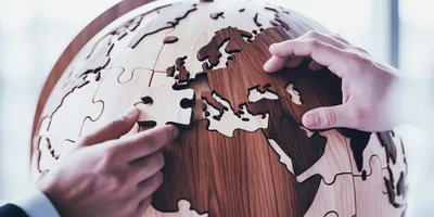 Business People Assembling Wooden World Map Puzzle