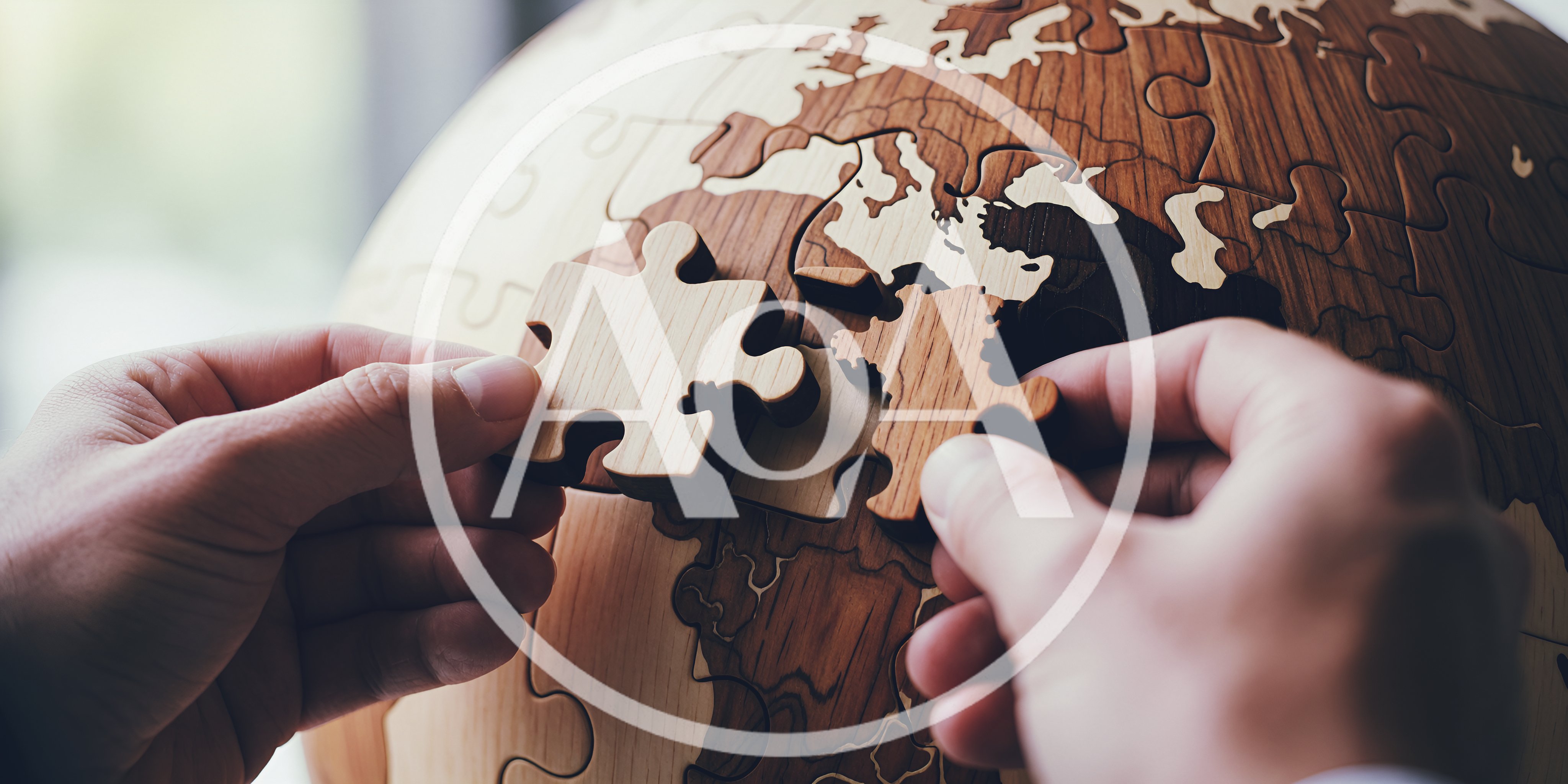Hands Assembling Wooden World Map Puzzle