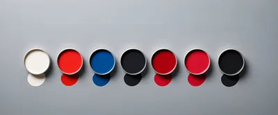 Seven Open Paint Cans With Colorful Spills