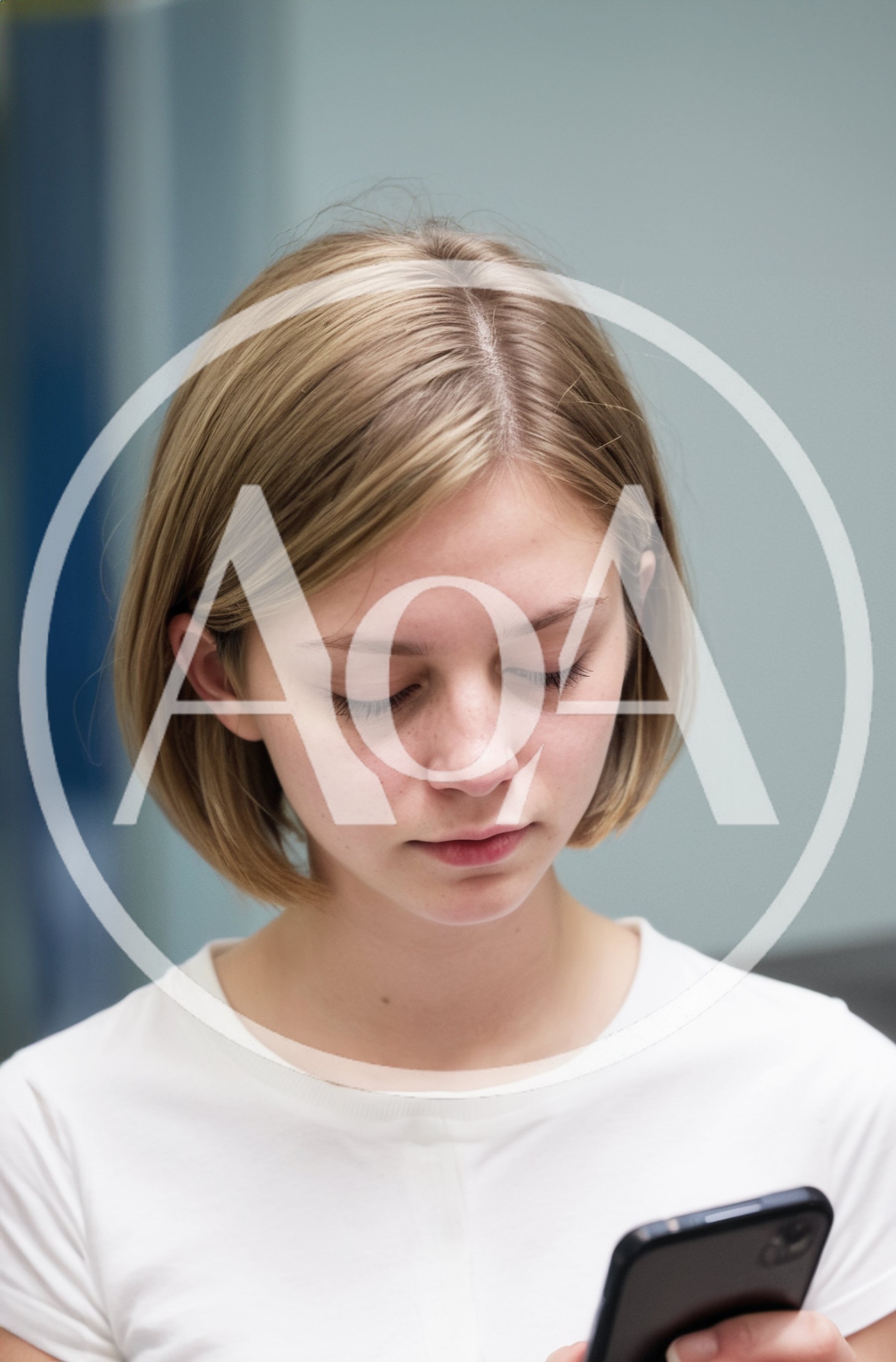 Young Woman Looking Down At Her Smartphone