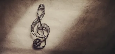 Metal Treble Clef Sculpture On Textured Paper Background