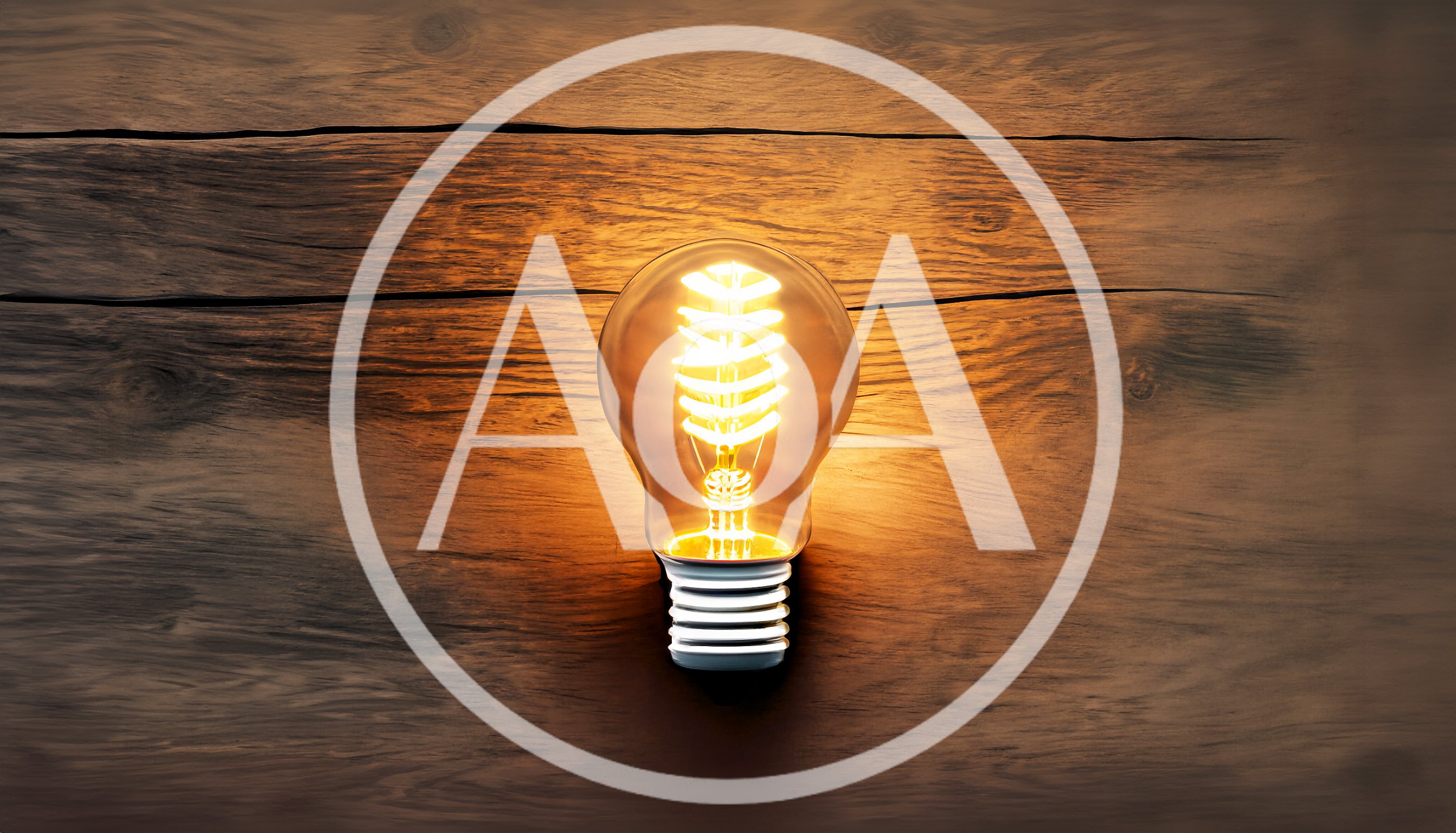 Glowing Spiral Filament Light Bulb On Wooden Surface