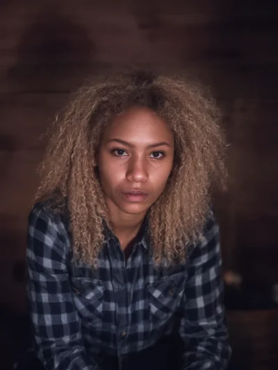 Portrait Of A Young Woman With Curly Blonde Hair