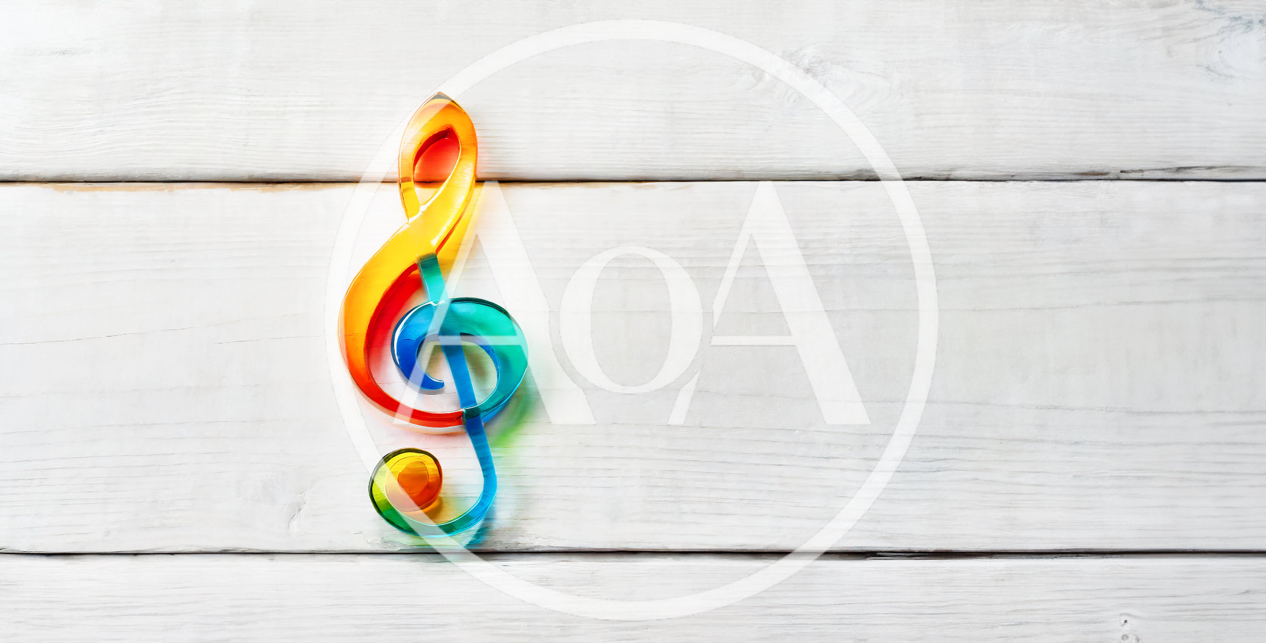 Colorful Glass Treble Clef on White Wooden Background