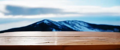Wooden Table Surface Overlooking Snowy Mountain Landscape