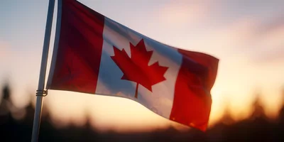 Canadian Flag Waving Against A Sunset Sky