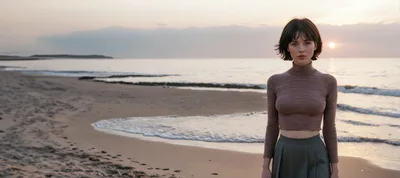 Young Woman Standing On Beach At Sunset
