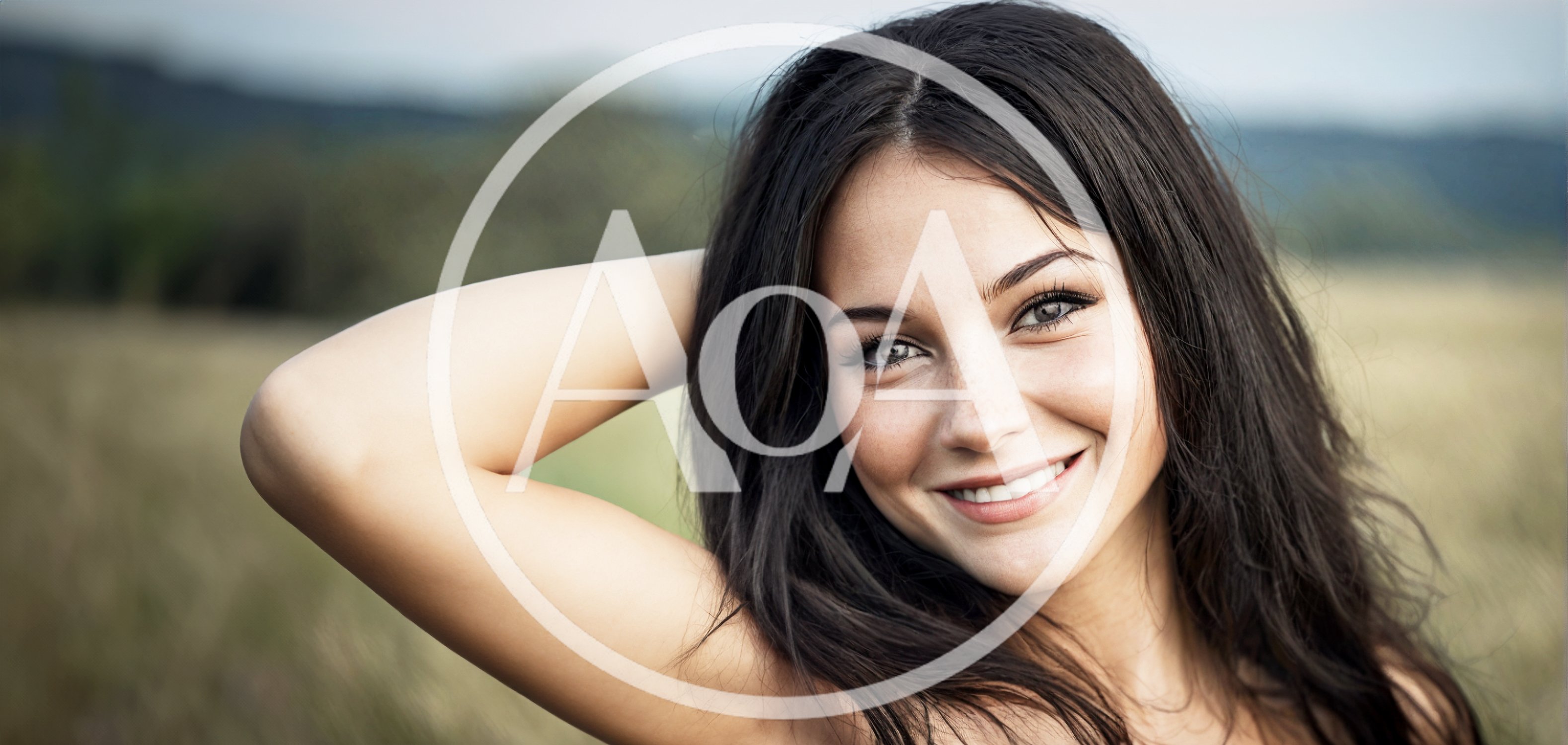 Smiling Young Woman Posing In A Grassy Field
