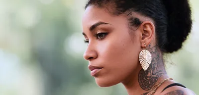Profile Portrait Of A Young Woman With Tattoos