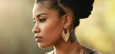 Profile Portrait Of A Woman With Gold Earrings