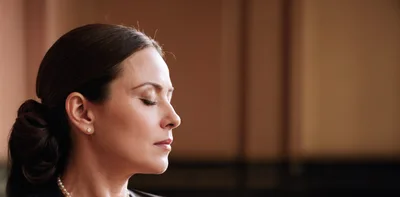 Side Profile Of A Woman Meditating With Eyes Closed