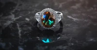 Oval Cut Alexandrite Ring on Dark Marble Surface