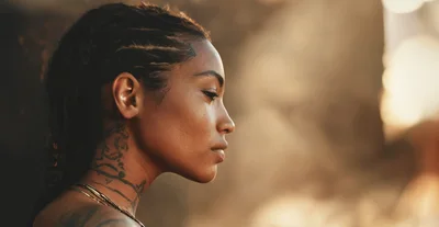 Profile Portrait Of A Young Woman With Neck Tattoos