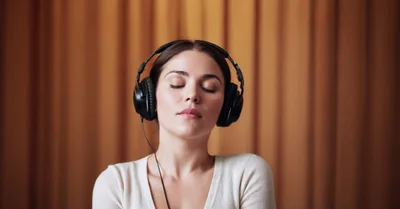 Young Woman Listening To Music With Headphones