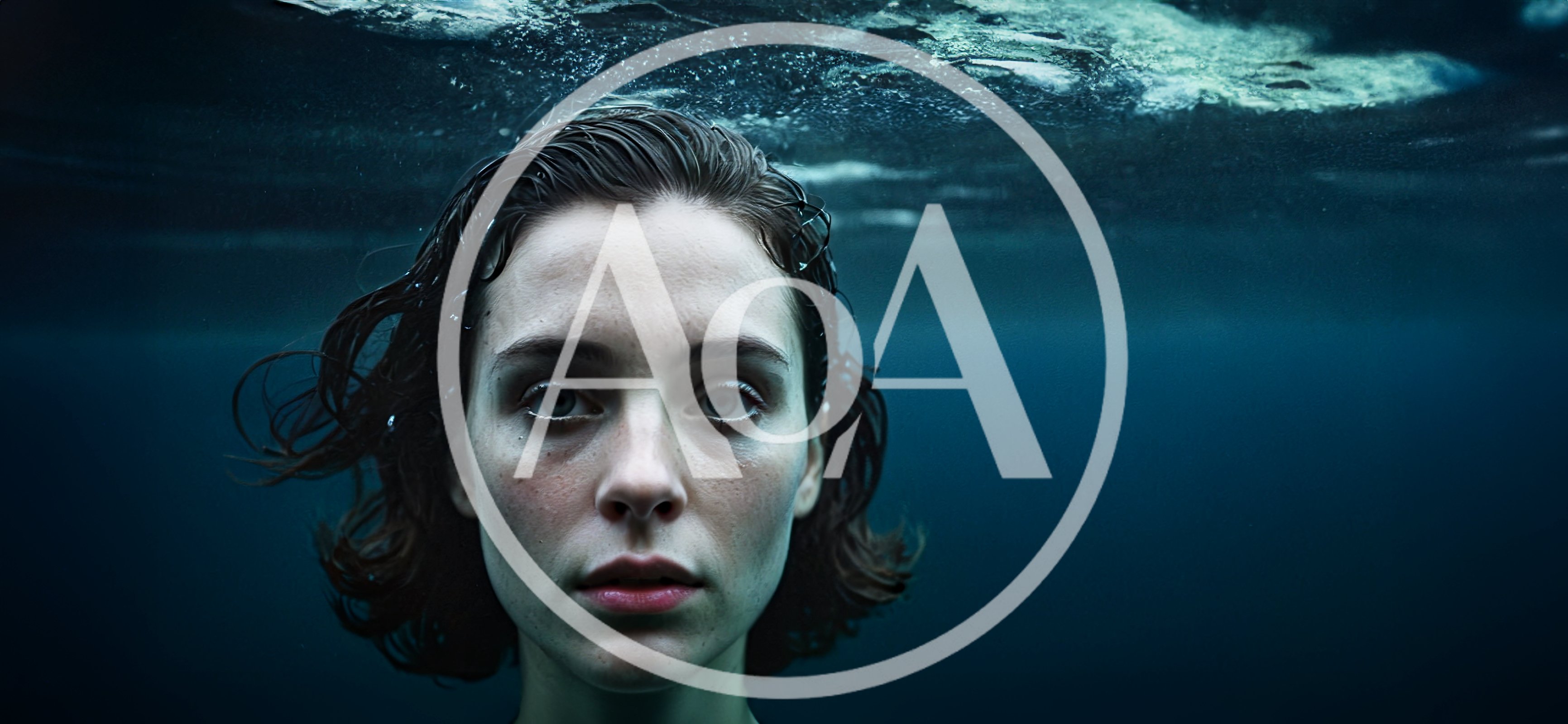 Woman Submerged Underwater Looking Directly At Camera