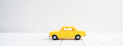 Yellow Toy Car On White Wooden Surface
