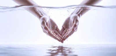 Cupped Hands Holding Water Surface