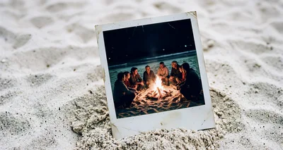 Polaroid Photo Of Friends Sitting Around A Beach Bonfire