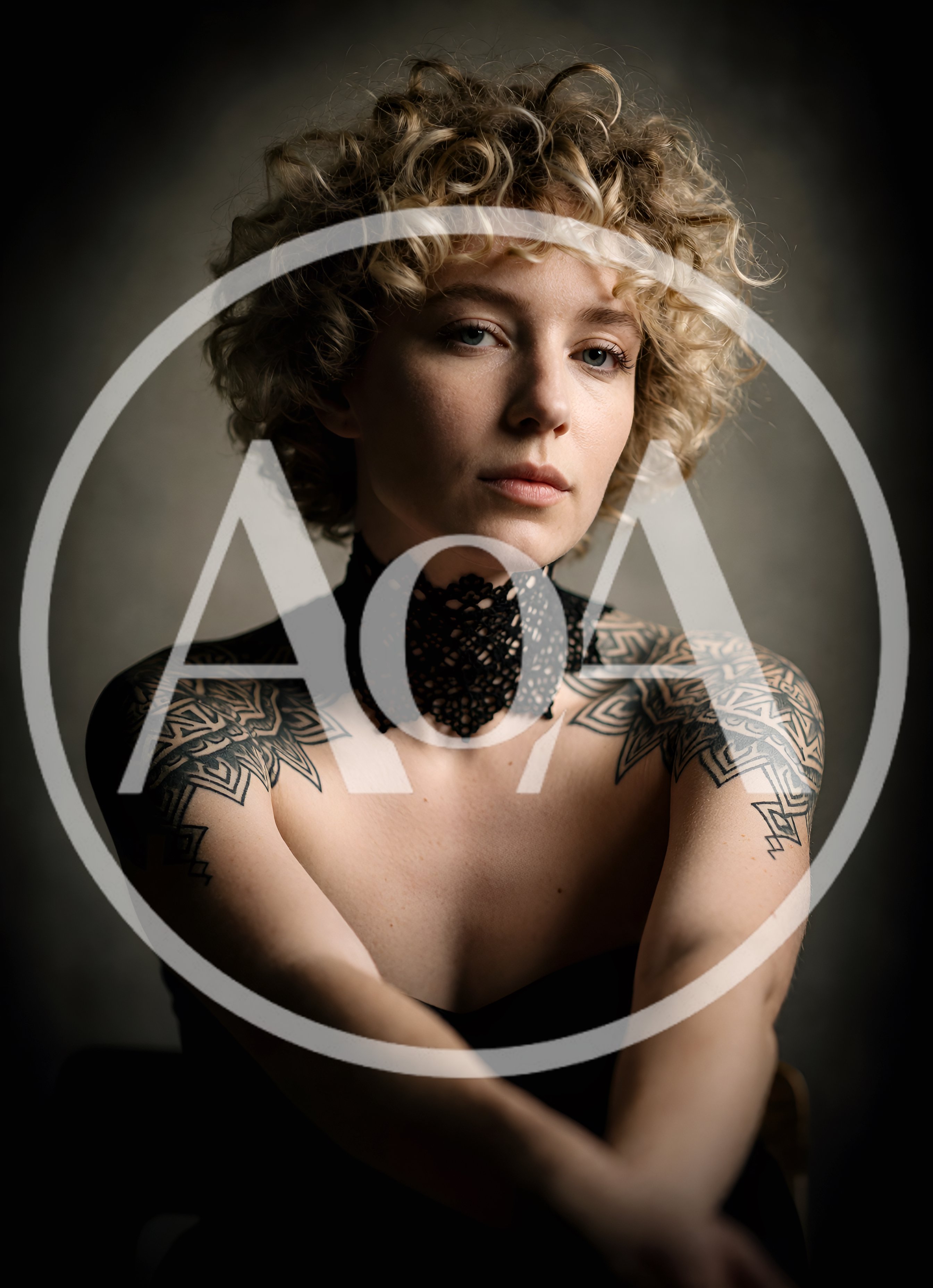 Portrait Of A Woman With Curly Blonde Hair And Tattoos