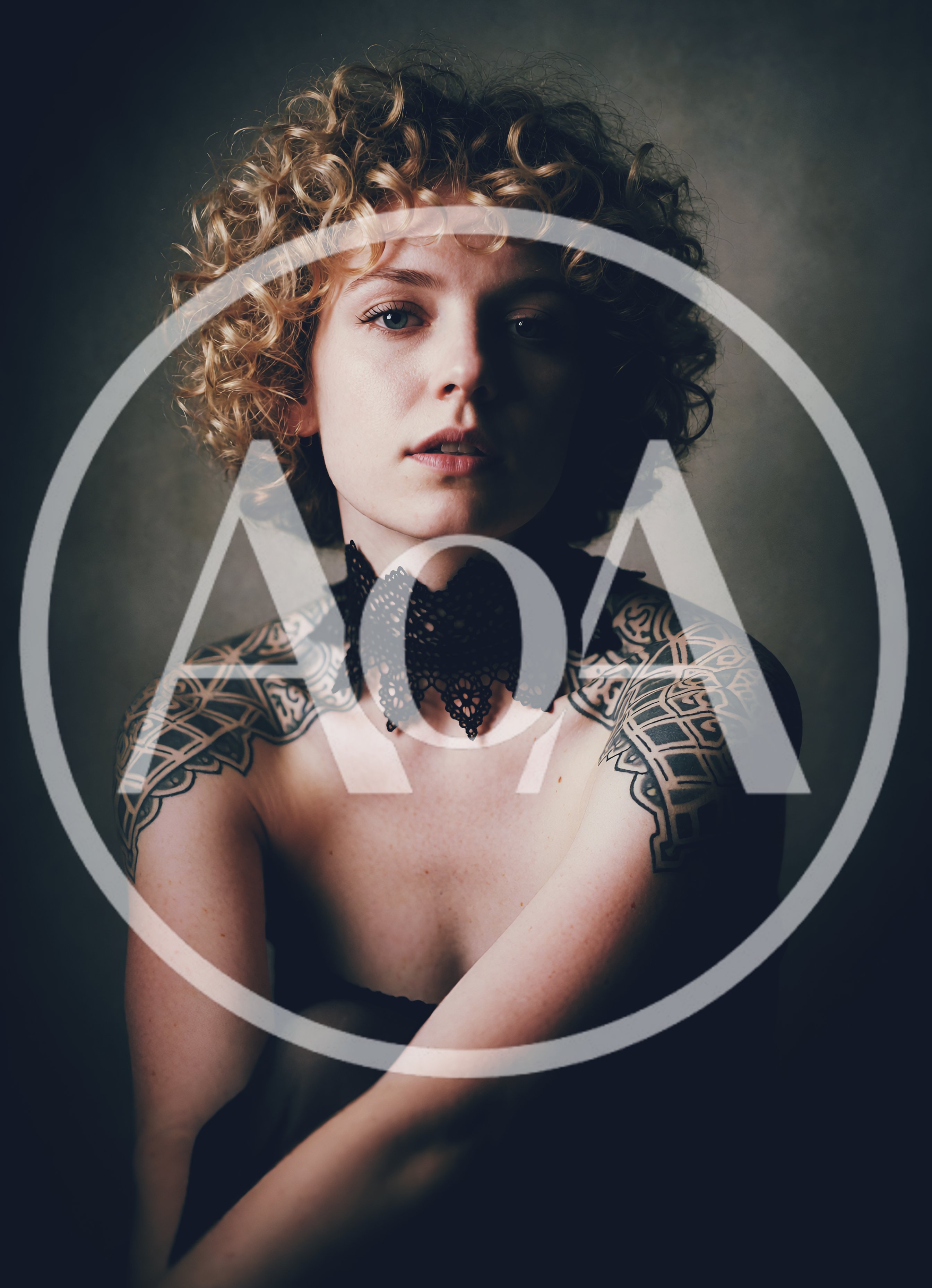 Portrait Of A Young Woman With Curly Hair And Tattoos
