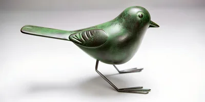 Green Metal Bird Figurine On White Background