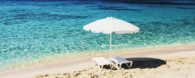 White Beach Umbrella And Lounge Chairs On Tropical Shore