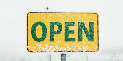 Yellow Open Sign Covered In Winter Snow