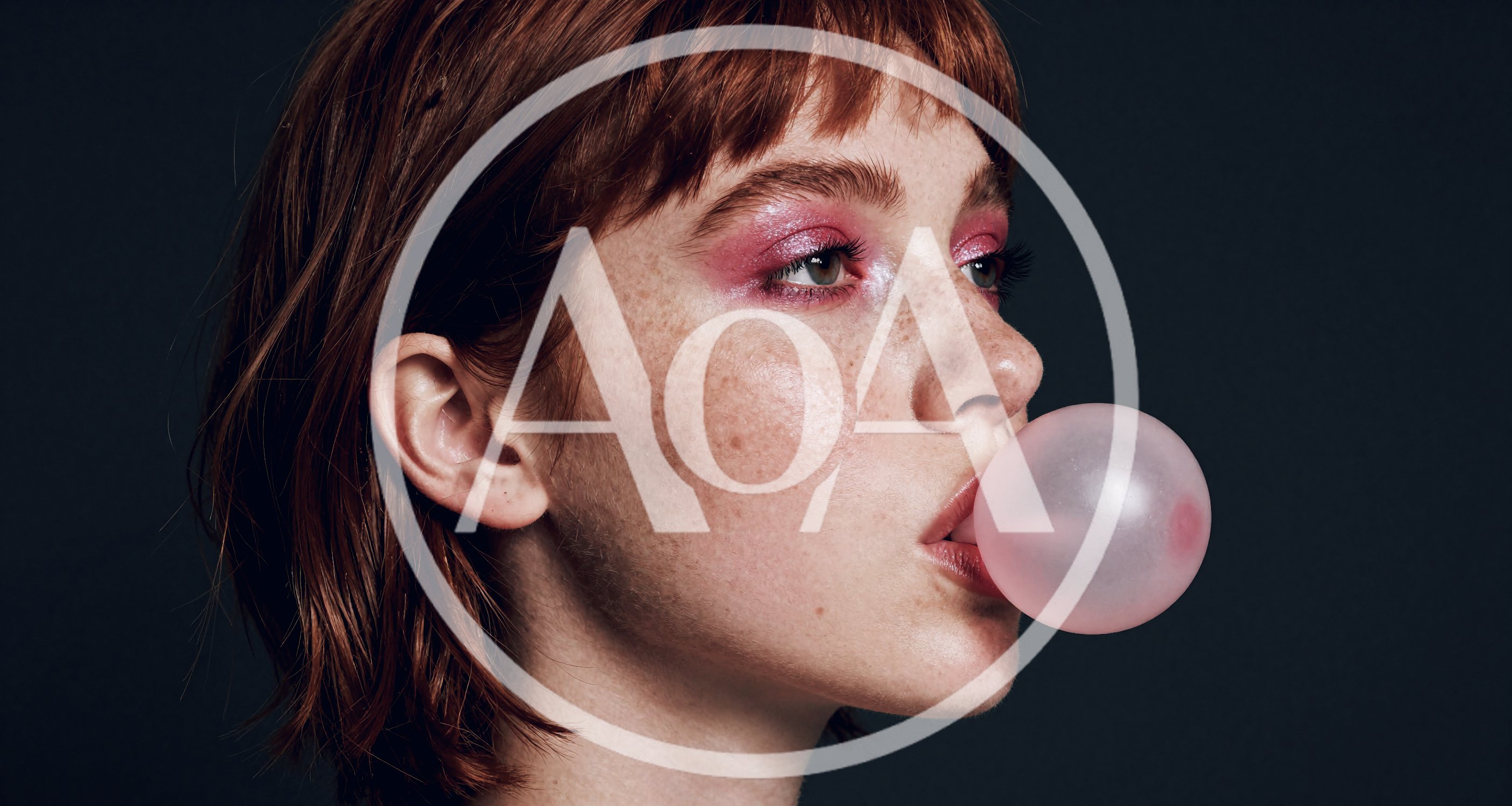 Young Woman With Freckles Blowing A Pink Bubblegum Bubble