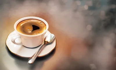 White Cup Of Black Coffee On A Saucer