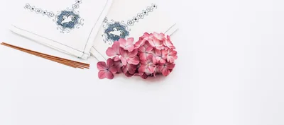 Incense Sticks and Hydrangea Flowers on Embroidered Napkins