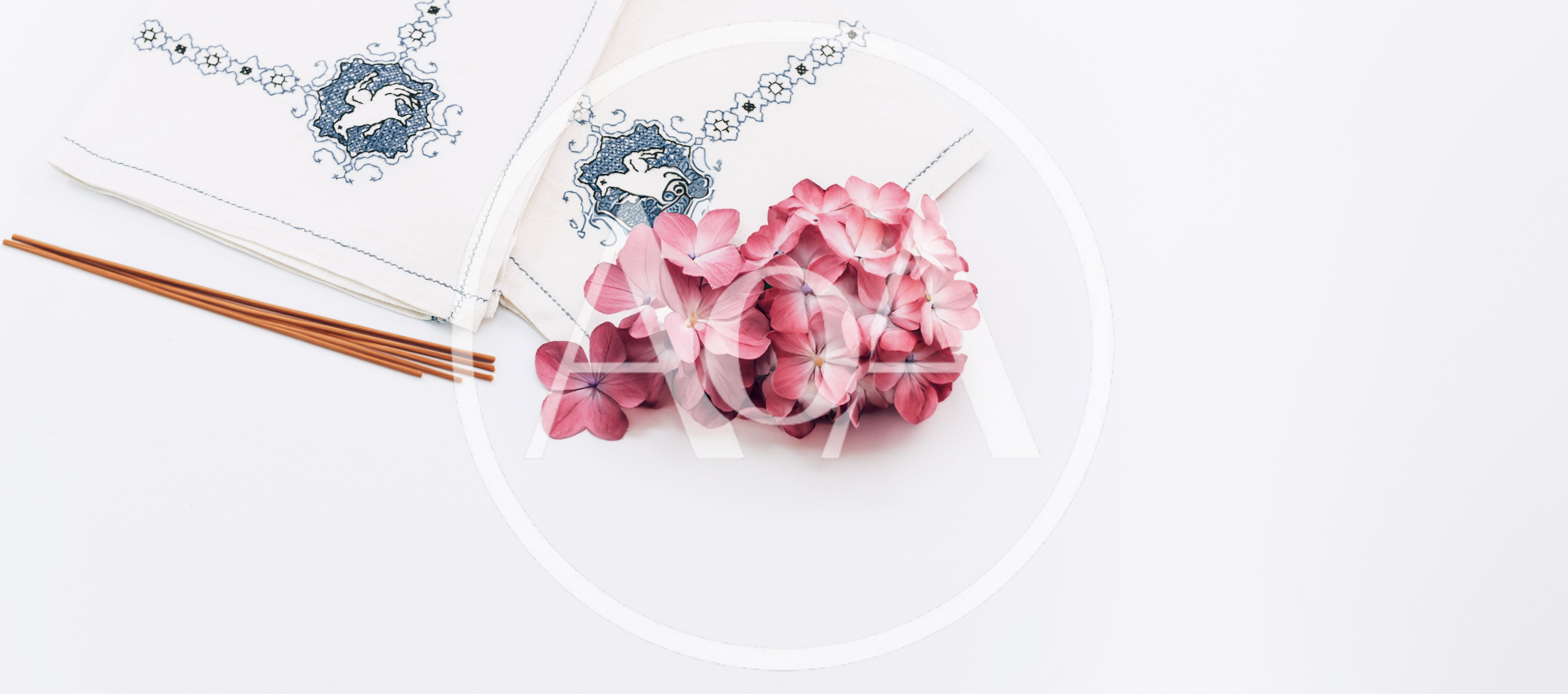 Incense Sticks and Hydrangea Flowers on Embroidered Napkins