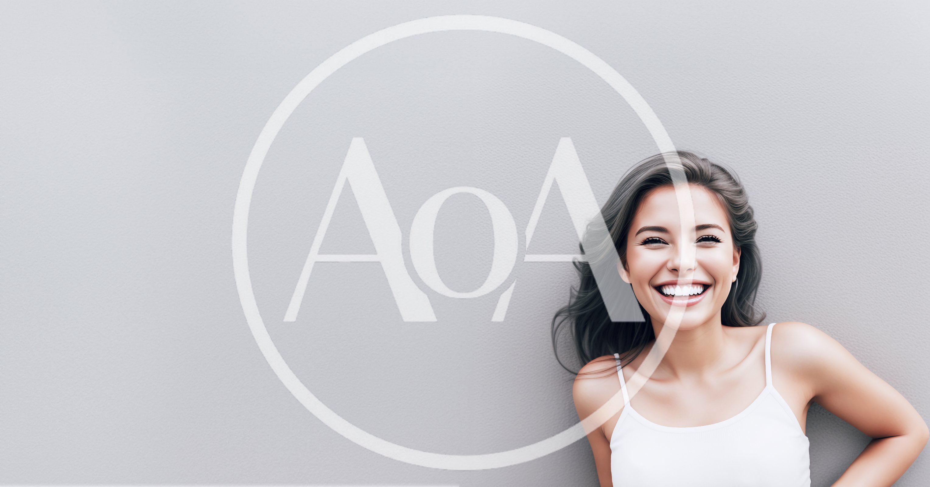 Smiling Young Woman Against A Plain Gray Background