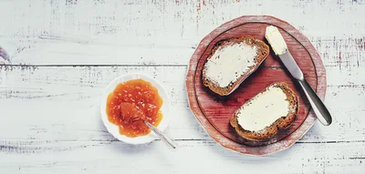 Two Slices Of Buttered Bread With Apricot Jam