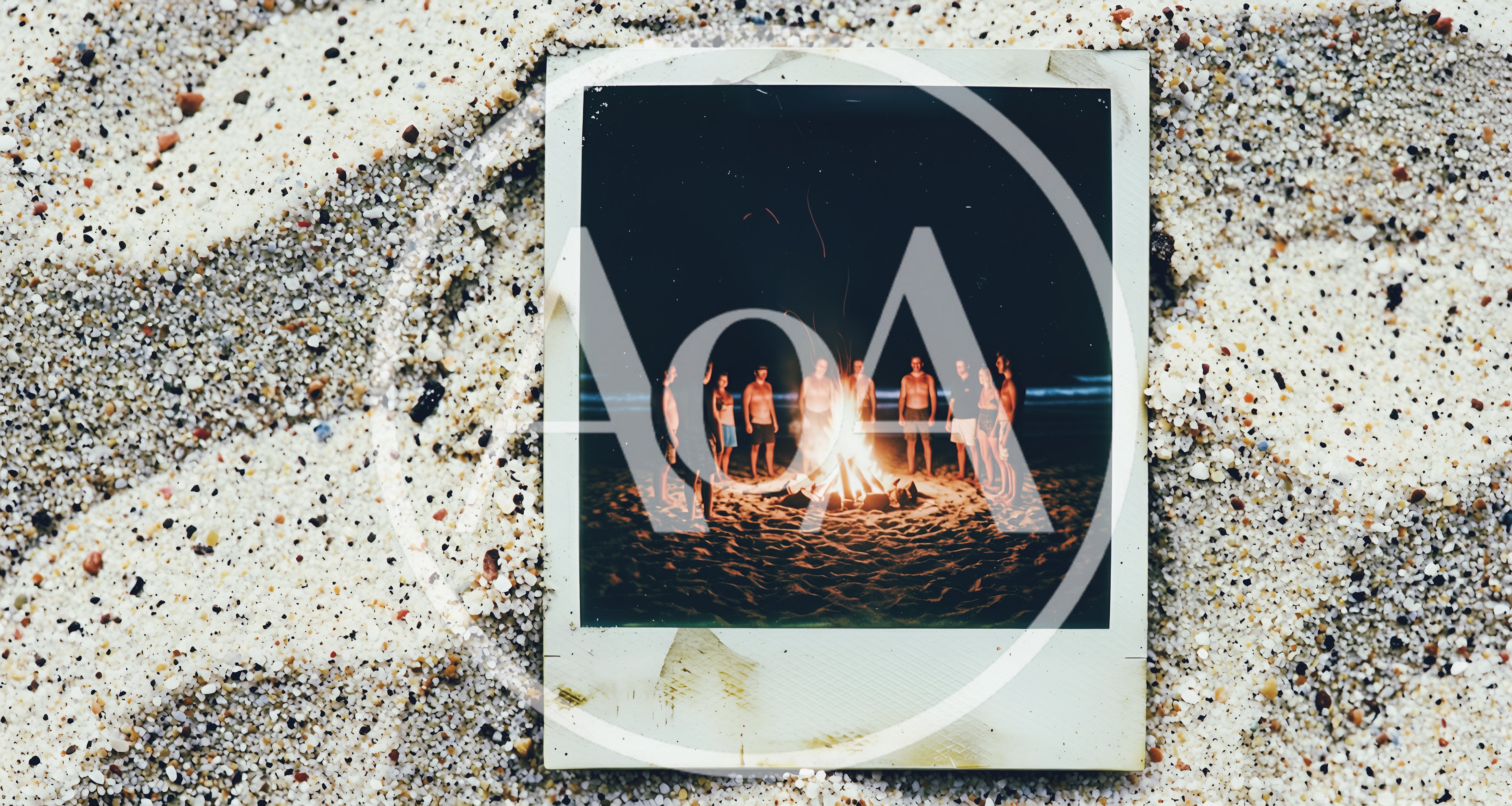 Group Of Friends Gathering Around A Beach Bonfire