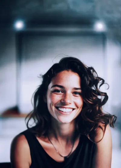 Portrait Of A Smiling Young Woman With Curly Hair