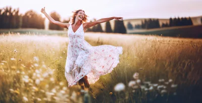 Happy Woman Running Through A Wildflower Meadow