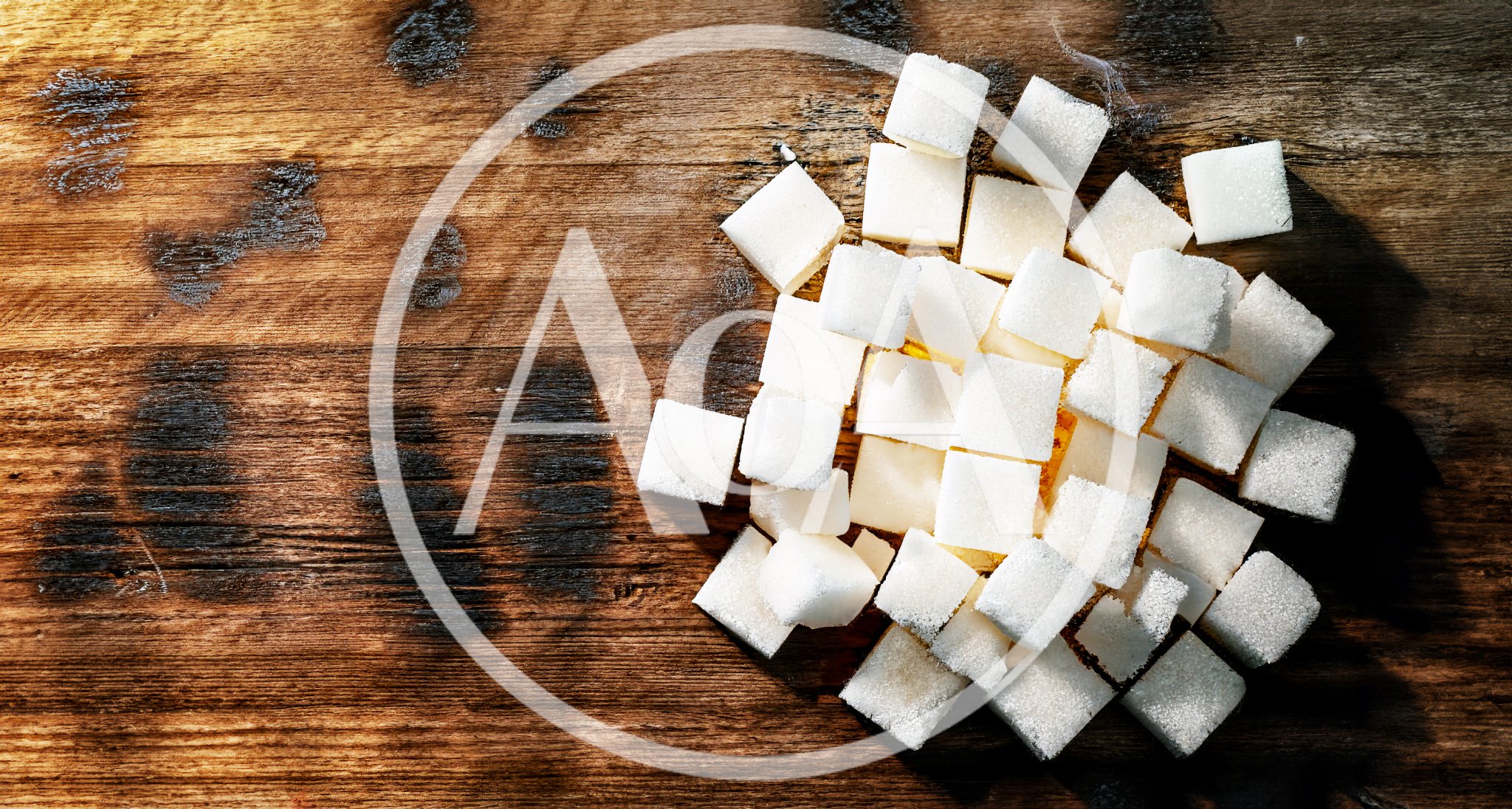 White Sugar Cubes Scattered On A Wooden Table
