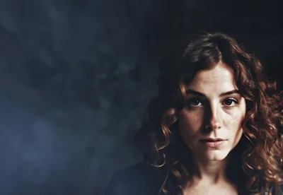 Portrait Of A Young Woman With Curly Hair