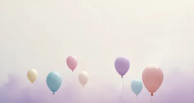 Pastel Colored Balloons Floating Against A Soft Hazy Background