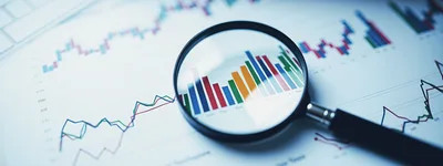 Magnifying Glass Over Financial Stock Market Charts