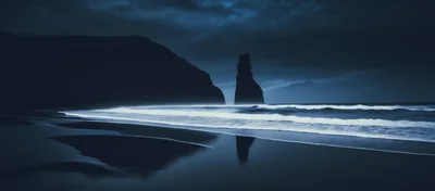 Dramatic Sea Stack On A Dark Moody Beach