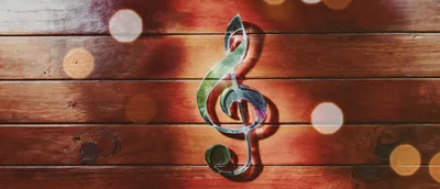 Reflective Treble Clef Symbol on Wooden Background
