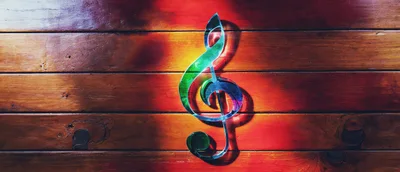 Glass Treble Clef Symbol On Wooden Background