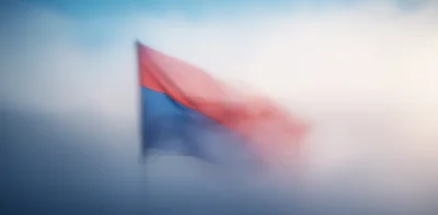 Red And Blue Flag Waving In Thick Fog