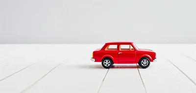 Red Toy Car On White Wooden Surface