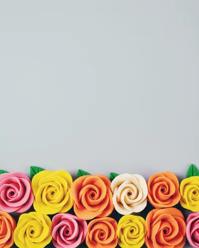Colorful Clay Rose Flowers Border on Grey Background