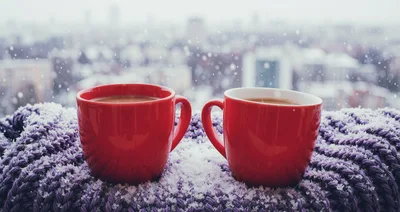 Two Red Coffee Mugs On A Snowy Purple Scarf