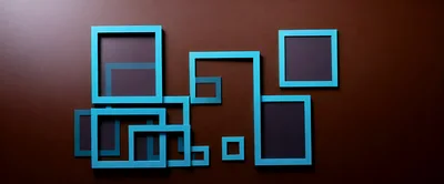 Abstract Blue Picture Frames On Brown Wall