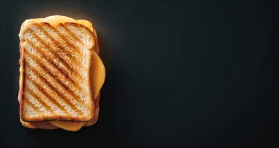 Grilled Ham and Cheese Sandwich on Dark Background