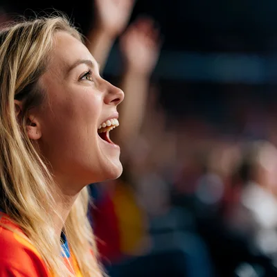 Excited Young Woman Cheering At A Sports Stadium